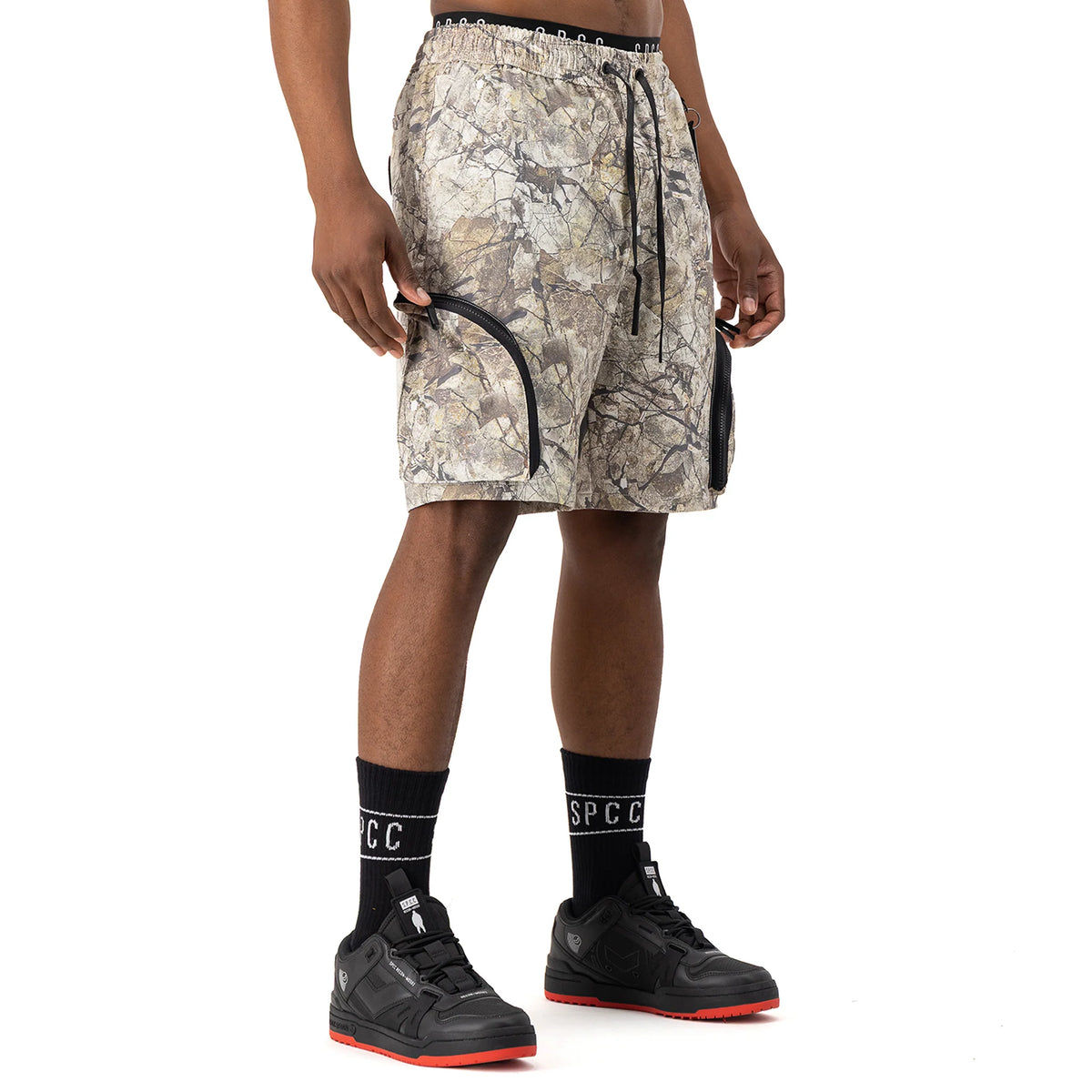 Men's SPCC Incognito Woven Short in stone color, casual bermuda style with a relaxed fit and woven fabric, front and side view.