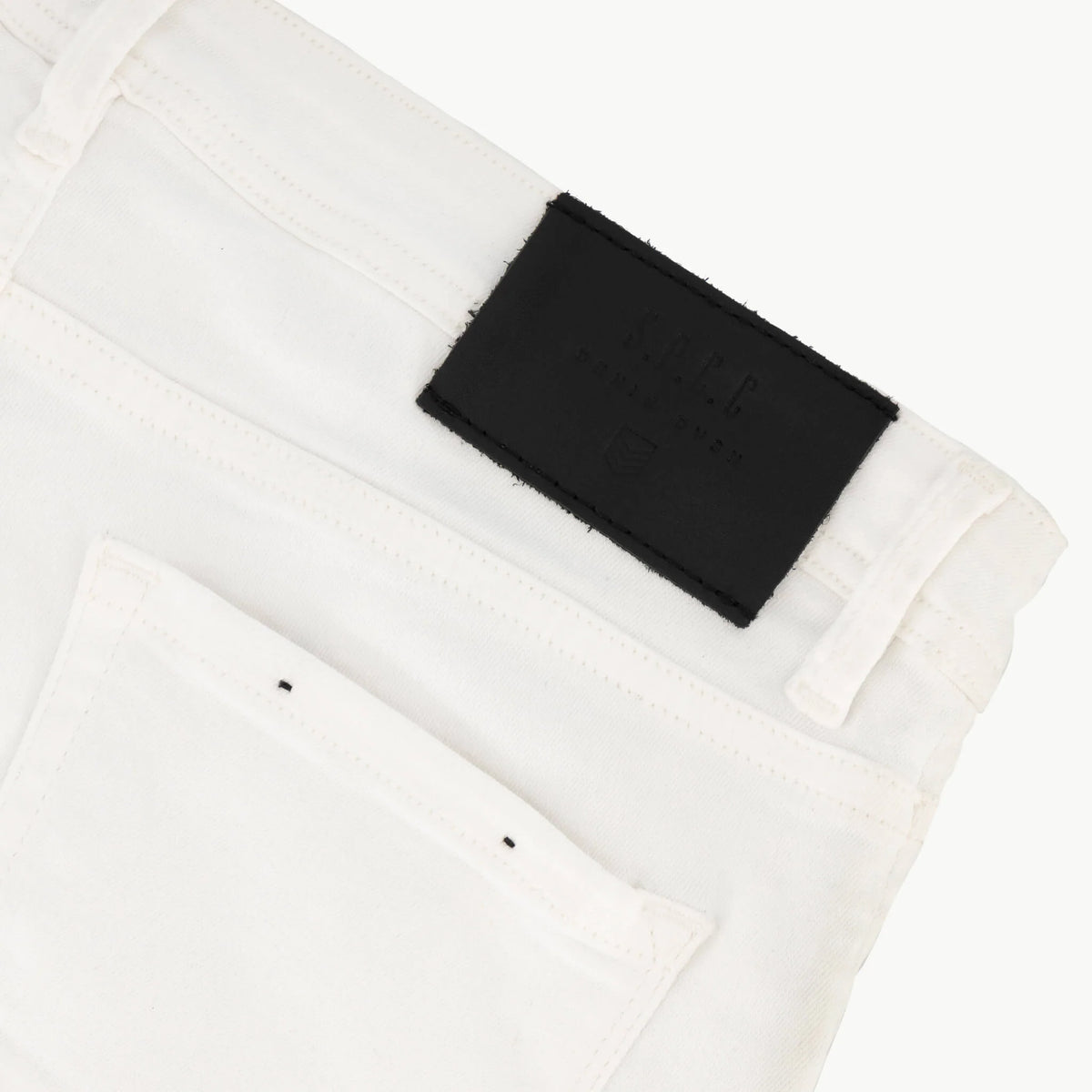 White SPCC Shadowfax men's jeans with classic fit and denim texture, shown hanging on a plain background.