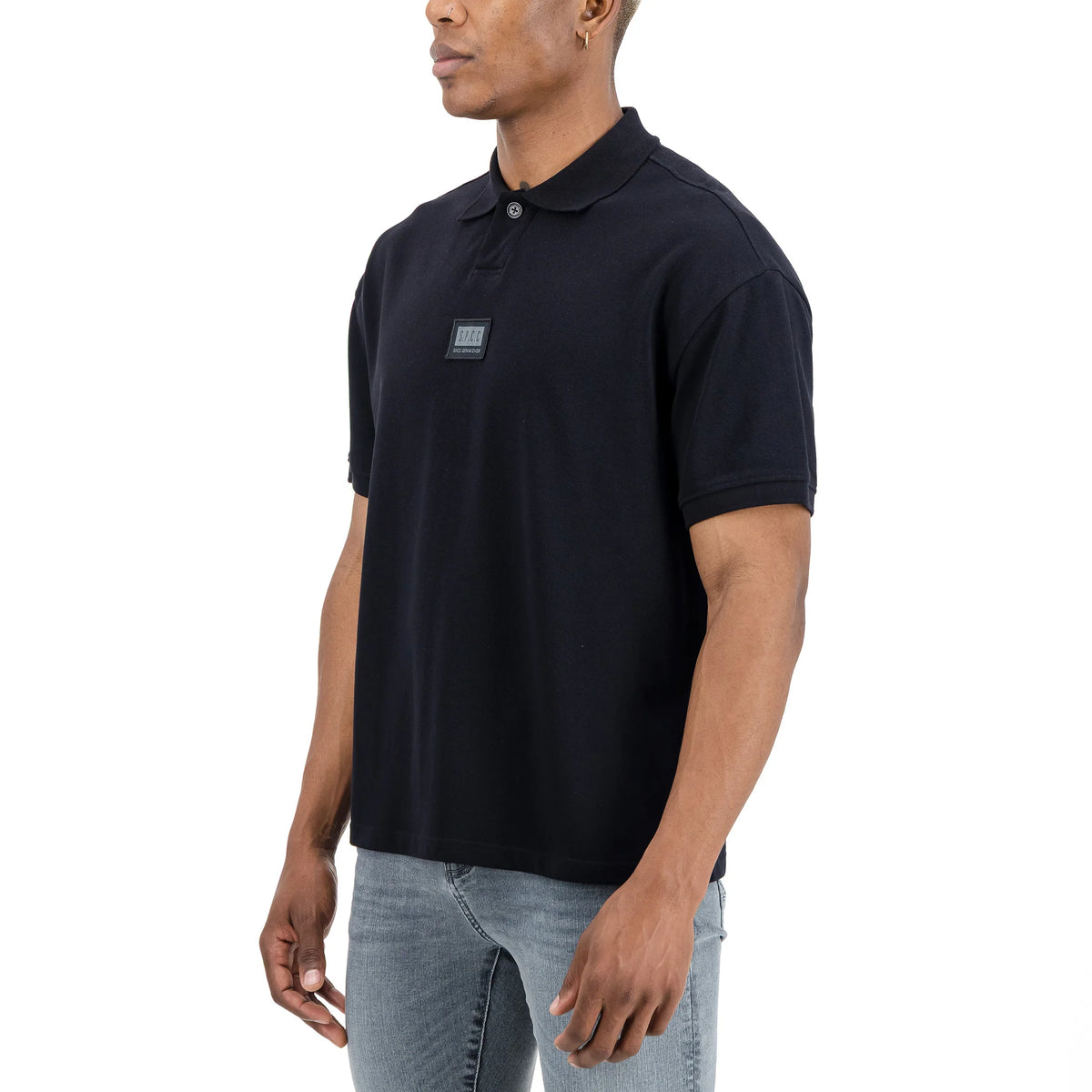 Men's black SPCC Nohr golfer with a classic polo collar, short sleeves, and subtle branding on the chest.