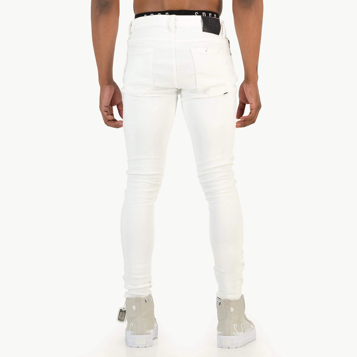 Men's white SPCC Shadowfax jeans with classic five-pocket design and straight fit, shown on a model.