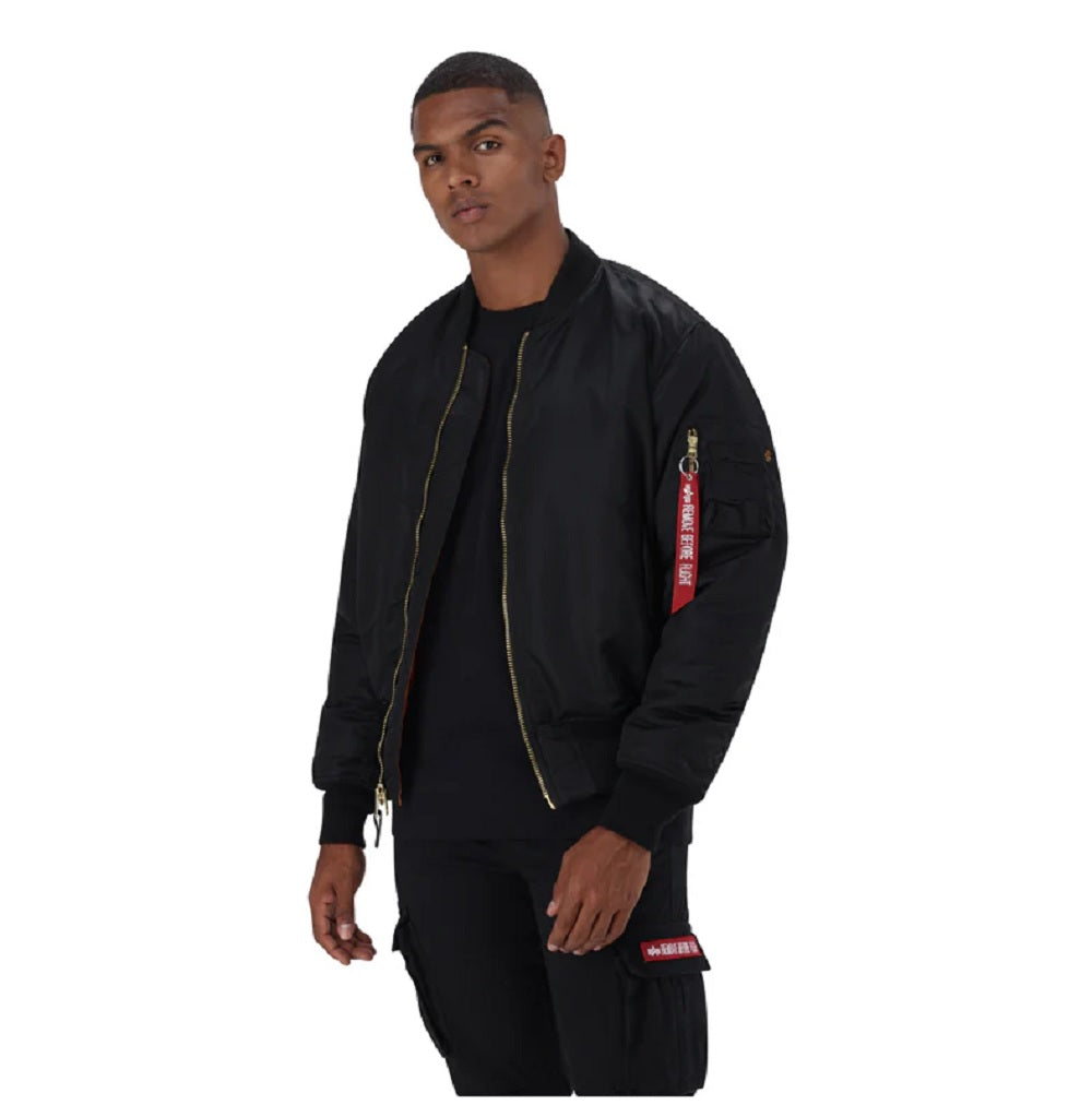 Unisex Alpha MA-1 Classic Black jacket with ribbed collar and cuffs, shown on a hanger against a plain background.