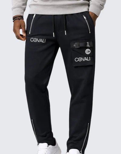 Black Covali Aprega men's track pants with a relaxed fit, elastic waistband, and subtle branding detail.