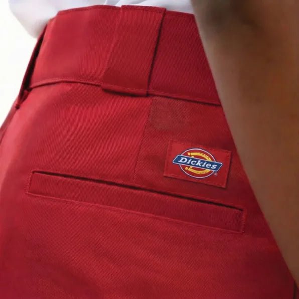 Red Dickies 847 men's trousers shown in a front view, featuring classic workwear style and durable fabric.