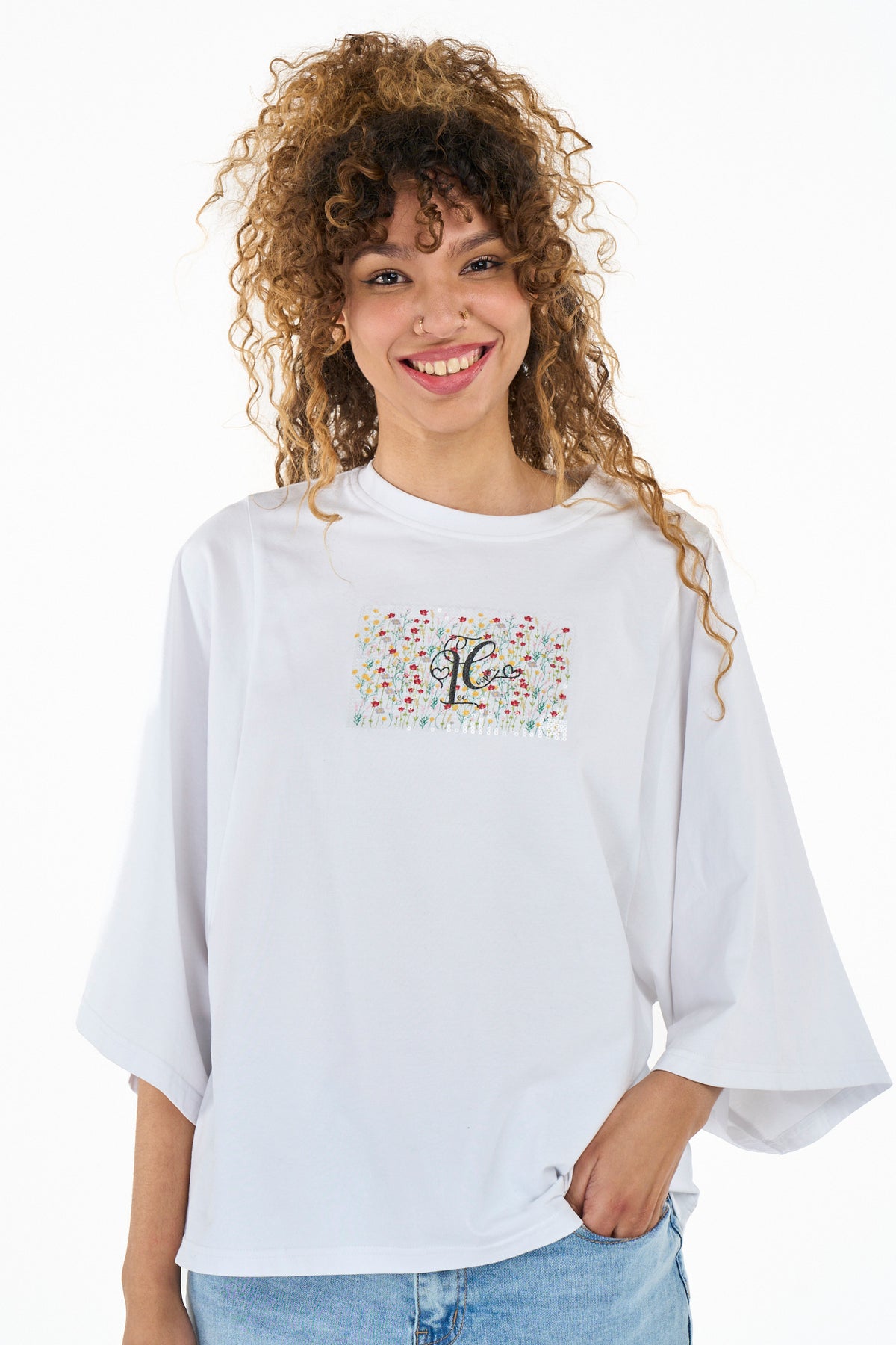 White Lee Cooper Blythe women's T-shirt with a relaxed fit and short sleeves, displayed on a hanger.