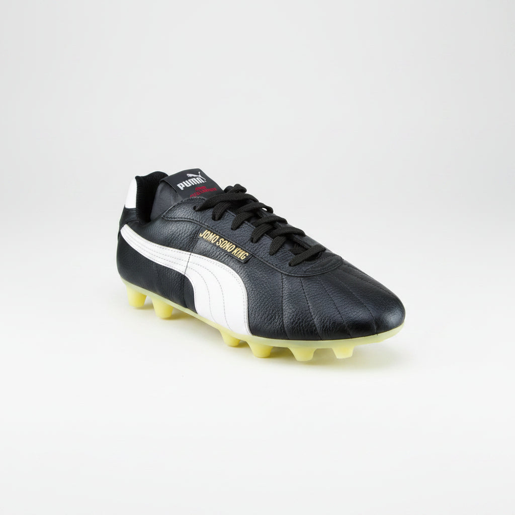 PUMA Jomo Sono King DP soccer boots in black with white accents, designed for optimal performance on the field.