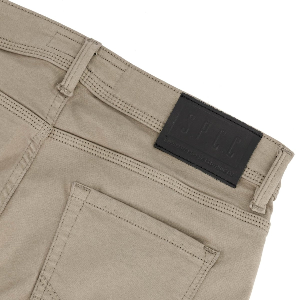Dark stone SPCC Rodan men's jeans with classic fit and denim texture, shown hanging on a wooden background.