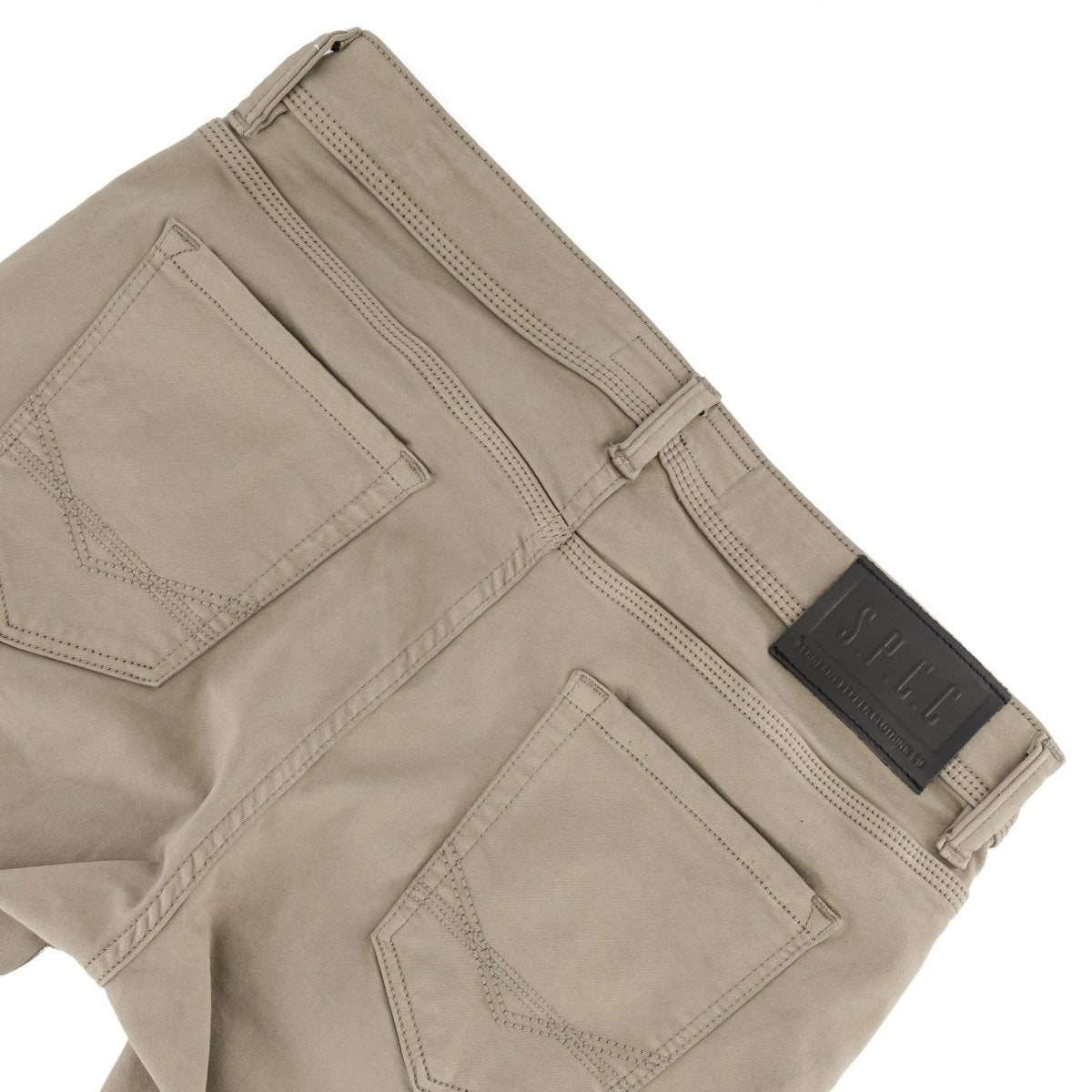 Dark stone SPCC Rodan jeans for men, showing a close-up of the slim fit denim with detailed stitching and classic five-pocket design.