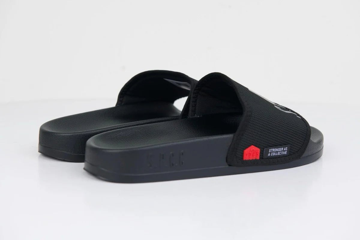 Men's black SPCC Surge Dusk Slider sandals with cushioned straps and textured soles for comfortable casual wear.