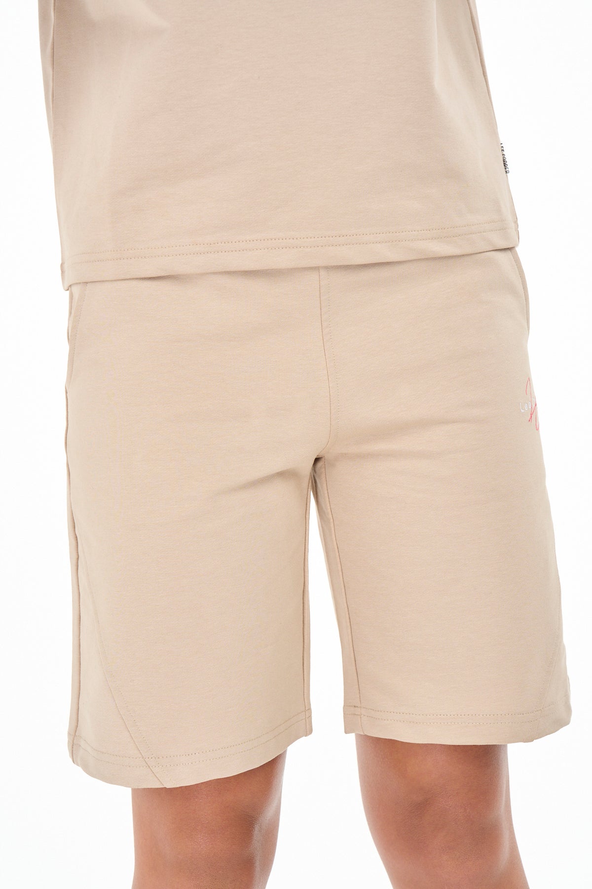Beige Lee Cooper Sloan girls' Bermuda shorts with adjustable waistband and casual style, perfect for kids' summer outfits.