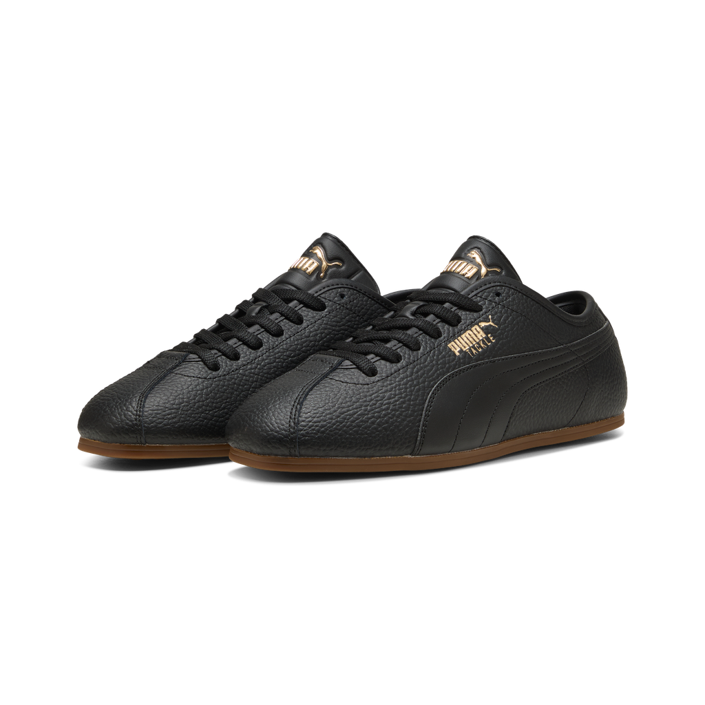 Puma men's Tackle L sneakers in black, gold, and gum with front view, showcasing sleek athletic design and branding.