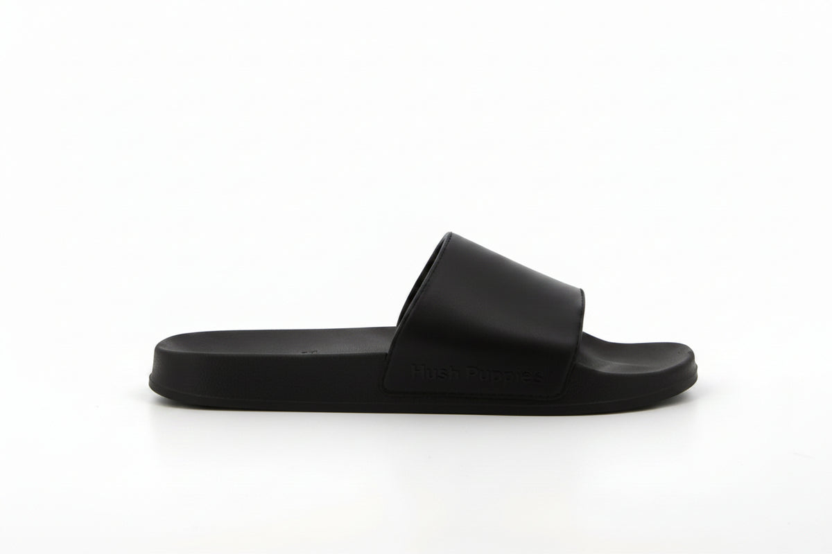 Men's black Hush Puppies slide sandals with cushioned footbed and open-toe design, perfect for casual summer wear.
