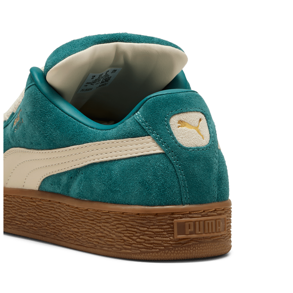 Puma men's Suede XL sneakers in black and white with suede upper and rubber sole, casual athletic footwear.