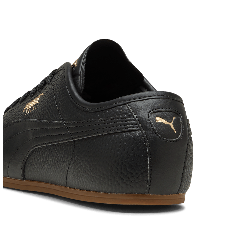 Puma men's Tackle L sneakers in black, gold, and gum colorway with sporty design and Puma logo on the side
