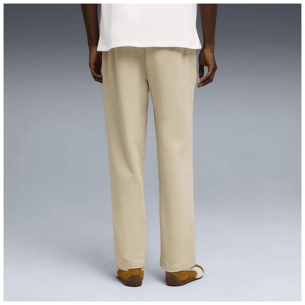 Puma men's Wardrope ESS relaxed track pants in black with elastic waistband and side pockets, made for comfortable casual wear.