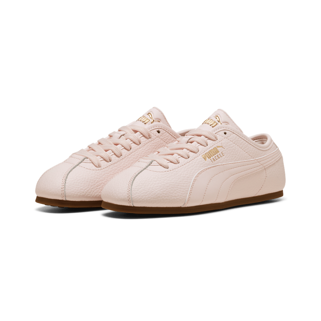 Puma women's Tackle L sneakers in black and white with cushioned soles and sleek athletic design.