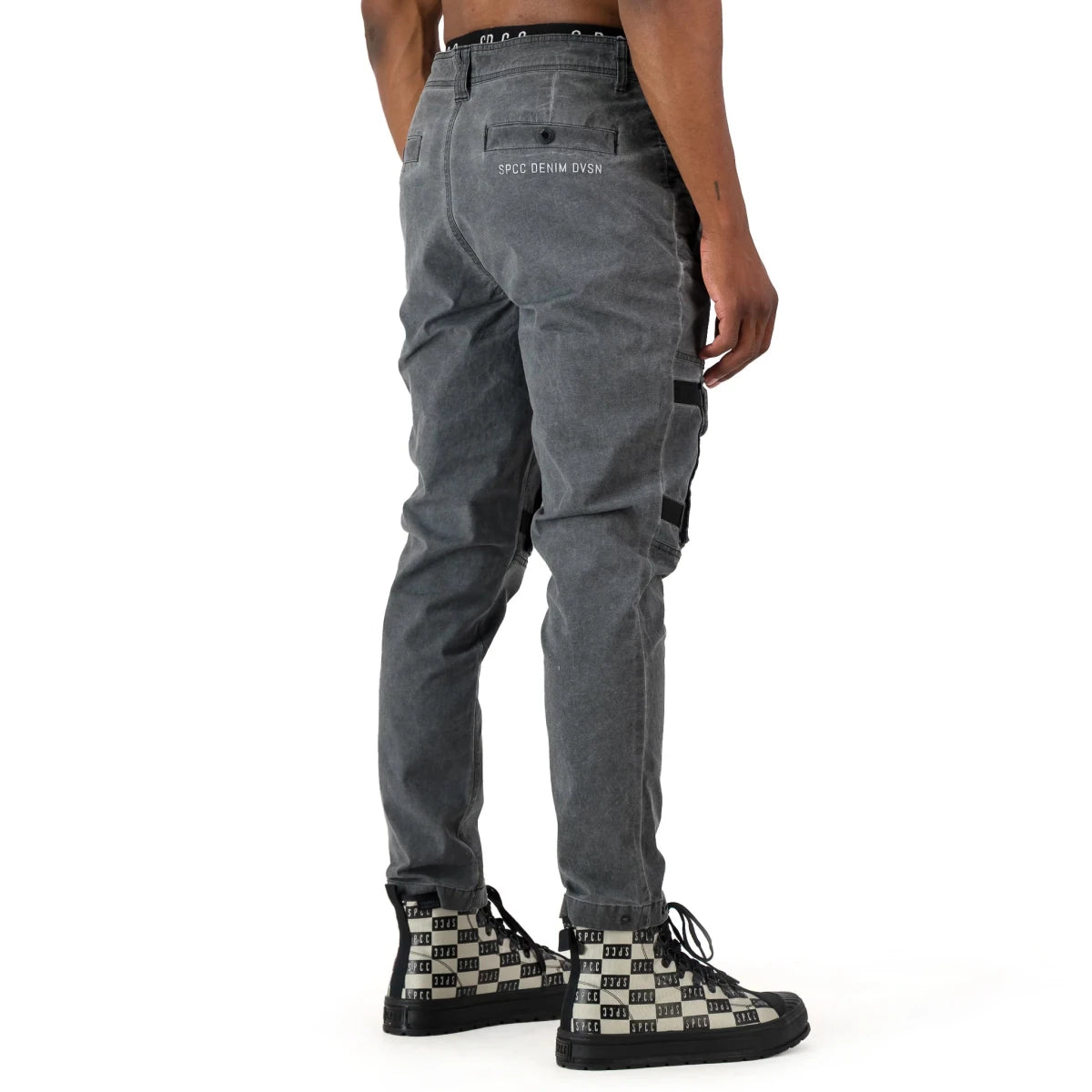 Black SPCC Alden cargo jeans for men, featuring multiple pockets and a relaxed fit, shown on a model.