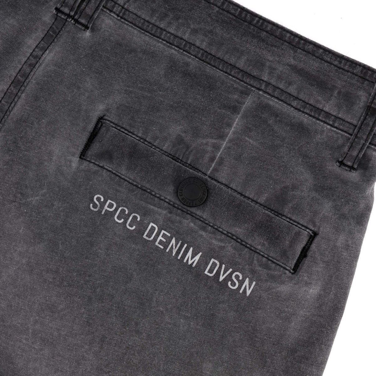 Men's SPCC Alden Cargo Jeans in black, featuring multiple pockets and a relaxed fit, displayed on a hanger.