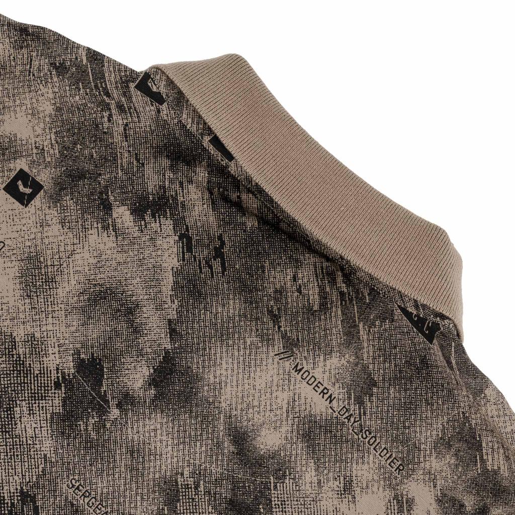 Men's SPCC Ronan Golfer in stone color, featuring a classic golf shirt with a collar and short sleeves.