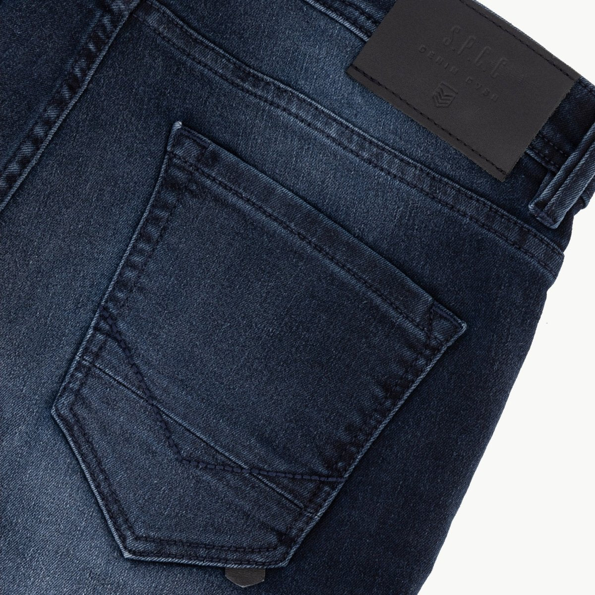 Men's SPCC Royale Indigo Jeans showing classic blue denim fabric with a slim fit design and front pockets.