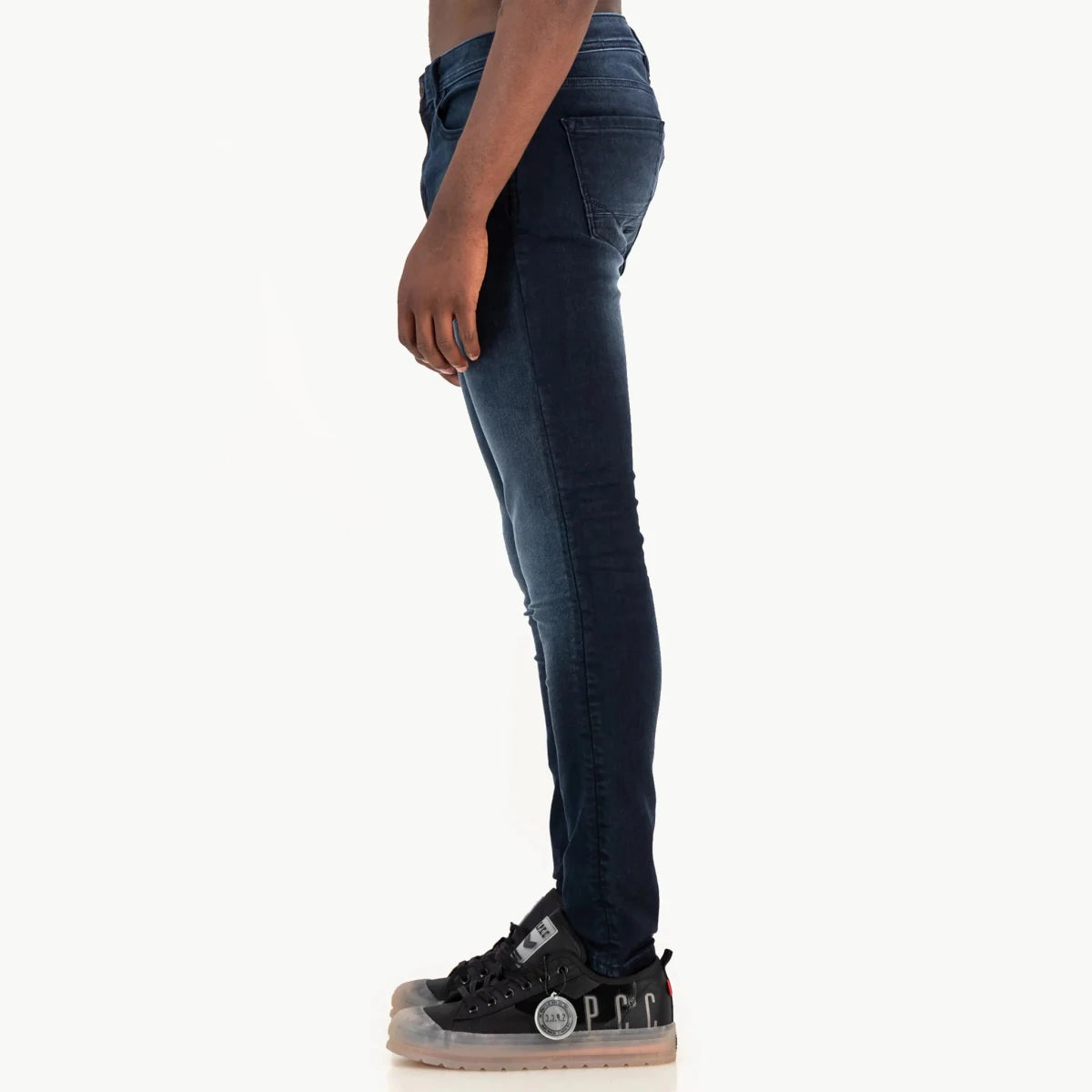 Mens SPCC Royale Jean in classic indigo denim, showcasing a slim fit with detailed stitching and five-pocket design.